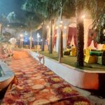 Haldi function decoration with yellow drapes and flowers